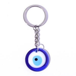 Blue evil eye keychain with glass nazar bead and silver metal ring on white background