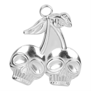Macro shot of silver skull cherry pendant made of polished stainless steel for DIY jewelry