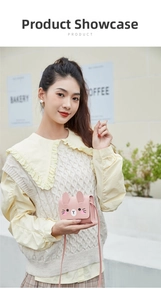 Pink rabbit crossbody bag featuring 3D ears on a female model in an outdoor setting