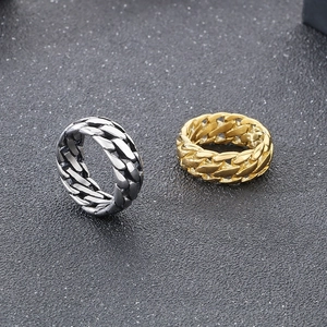 Detailed close-up of gold and silver titanium steel chain rings on dark background