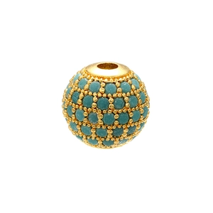 Macro shot of gold spherical bead with inlaid turquoise stones for DIY jewelry