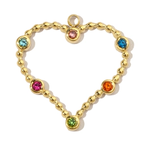 Macro view of heart-shaped gold pendant with colorful rhinestones and beaded texture