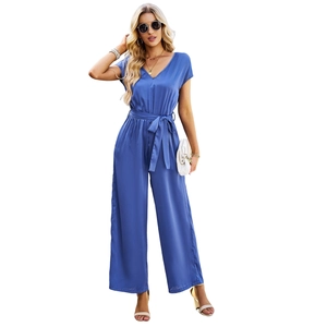 Blue short sleeve V-neck jumpsuit with belt and wide leg pants on white background