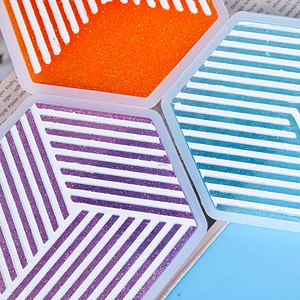 Detail showing colorful glitter hexagonal stripe coasters and DIY resin molds
