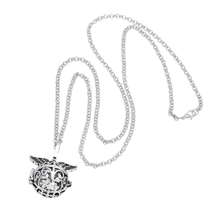 Macro shot of silver-tone hollow sphere pendant necklace with detailed wing design