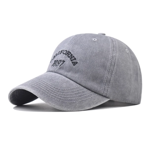 Detail of CALIFORNIA 1987 embroidery on washed gray distressed cotton baseball cap