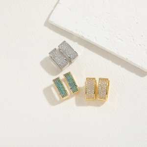 Three pairs of elegant square zircon earrings in gold and silver finish on stone