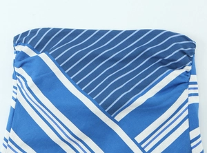 Detail of blue and white striped fabric showing fine texture and diagonal seam stitching