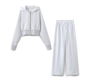 Flat lay of light grey cropped zip hoodie and high-waisted wide-leg knitted sweatpants