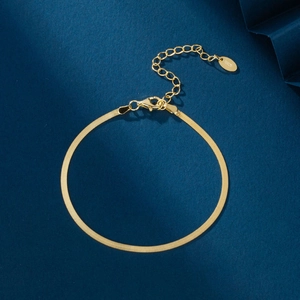 Close-up of golden S925 sterling silver flat snake chain bracelet with lobster clasp