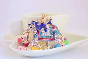 Close-up of golden elephant keychain with sparkling rhinestones and colorful enamel details