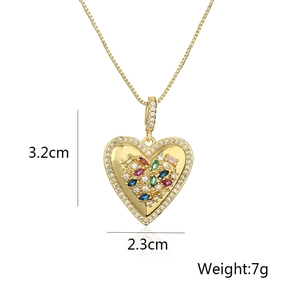 Detailed view of gold heart pendant with multicolor crystals and size 3.2cm x 2.3cm