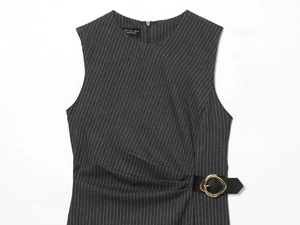 Detail of the waist buckle and pinstripe fabric texture on dark grey sleeveless dress