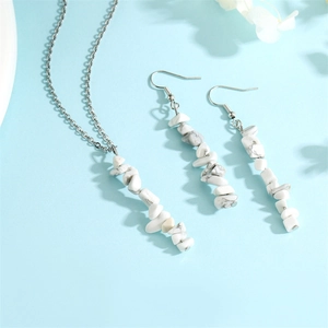 Detailed close-up of natural white crushed stone tassel earrings and necklace set