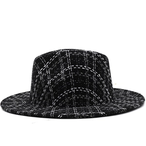 Detailed close-up of British style houndstooth wool fedora with flat wide brim