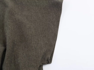 Close-up of deep olive green woven fabric showing natural linen cotton texture