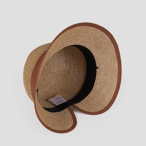 Detail view of straw sun hat interior with sweatband and wash label showing 57.5cm size
