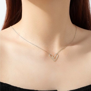Minimalist 925 sterling silver heart pendant necklace on a model's neck for a trendy look