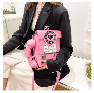Close-up of a pink retro telephone bag with a vintage dial and decorative lettering