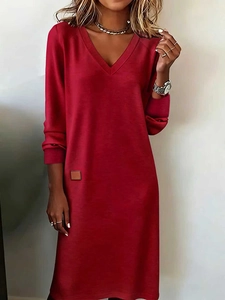 Detail of red V-neck long-sleeved dress with smooth knitted fabric and layered necklace