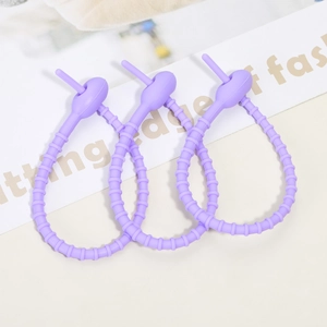 Three lavender silicone cable ties with adjustable segment buckles on a fashion card