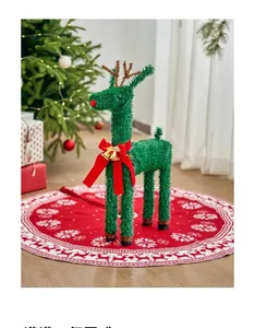 Detail view of a green glitter reindeer ornament with red velvet bow and golden bells