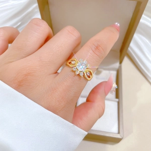 Macro view of gold flower ring with zircon petals and minimalist adjustable band