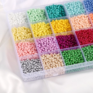Colorful macaron glass seed bead set in a transparent storage box on white satin