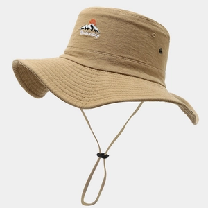 Detail of khaki outdoor sun hat featuring mountain embroidery and metal ventilation eyelets