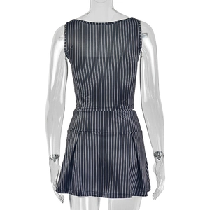 Detail view of the back of navy striped crop top and pleated skirt set on a model