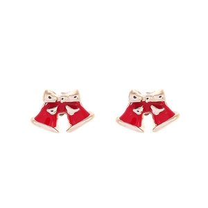 Close-up of festive red bell earrings with cream bows and golden finish accents