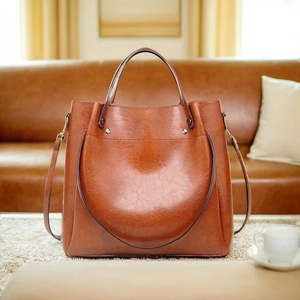 Macro detail of brown leather tote bag with vintage texture and metallic rivets