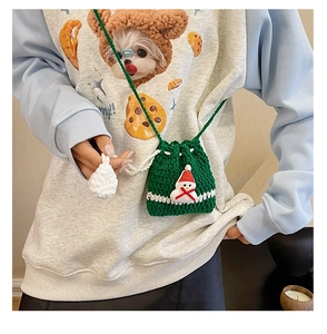 Close-up of handmade green crochet bag featuring a 3D snowman for Christmas outfits