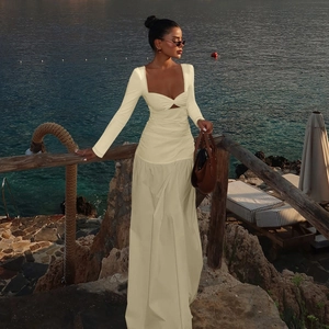 Detail of the elegant knot cutout and gathered waist on this cream maxi dress