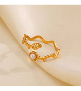 Detail of adjustable gold ring with delicate leaf motif and inlaid white pearl