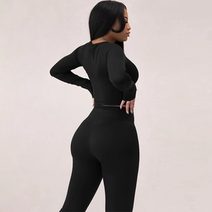 Detail of high-waist black yoga leggings with sculpting fit and elastic fabric