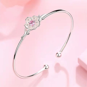 Adjustable silver cherry blossom cuff bracelet featuring a pink zircon center and matte petals