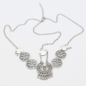 Close-up of bohemian silver metal forehead chain with crescent pendant and ethnic carving