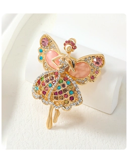 Macro detail of ballerina brooch with pink cat-eye stones and colorful rhinestones