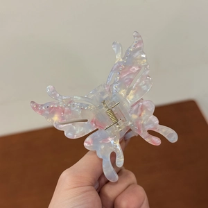Elegant acetate butterfly hair claw clip with colorful gradient and rhinestone accents