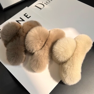 Detail showing plush faux fur hair claws in dark grey, khaki, and cream white shades