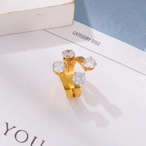 Detailed close-up of 18K gold-plated open ring with four sparkling white zircon stones