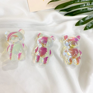 Iridescent laser bear phone socket grip with swirling purple textures on white satin