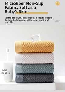 Detail showing folded thick cotton towels with embossed diamond pattern texture