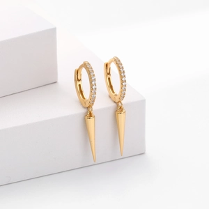 Detail of gold spike hoop earrings featuring micro-paved cubic zirconia stones