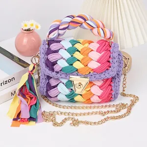 Detail of handmade crochet shoulder bag with rainbow weaving and golden metal buckle