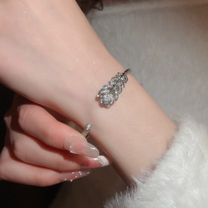 Detailed close-up of a silver plated feather bangle set with sparkling cubic zirconia crystals