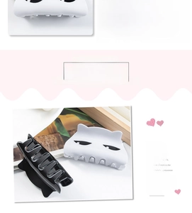 Close-up of black and white cartoon cat hair claws with minimalist eye design detail