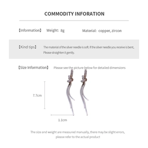 Detail view of silver knot earrings with zircon tassels and weight specifications