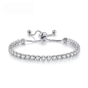 Detail of silver adjustable tennis bracelet featuring a sliding clasp and round clear crystals